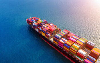 Aerial view of container cargo ship in sea.