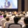 rear-view-audience-listening-speakers-stage-conference-hall-seminar-meeting-business-education-about-investment_41418-3462